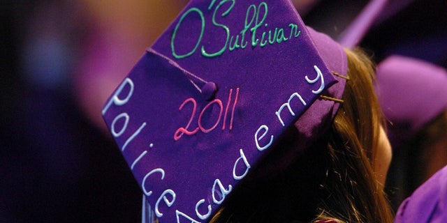 In this June 6, 2011, file photo, Tara O'Sullivan decorated her mortarboard with her police academy plans at College Park High School's commencement ceremony in Concord, Calif. (Karl Mondon/Bay Area News Group via AP, File)