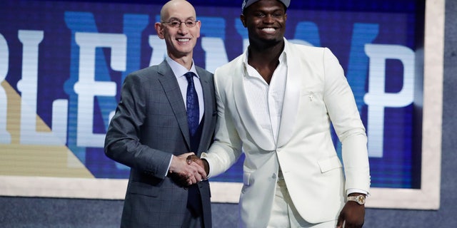 Duke's Zion Williamson, right, poses for photographs with NBA Commissioner Adam Silver after being selected by the New Orleans Pelicans as the first pick during the NBA basketball draft Thursday, June 20, 2019, in New York. (AP Photo/Julio Cortez)