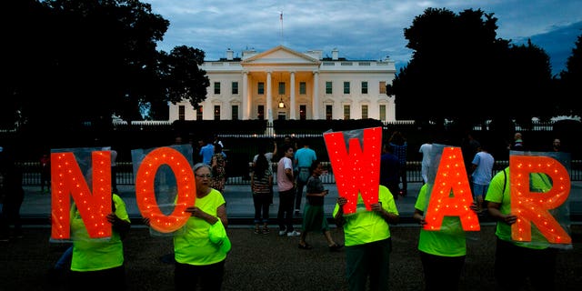 Protesters hold signs spelling out, "No War," outside the White House, Thursday June 20, 2019, in Washington, after President Donald Trump tweeted that "Iran made a very big mistake" by shooting down a U.S. surveillance drone over the Strait of Hormuz in Iran. 
