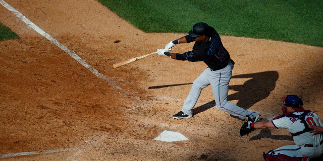 Miami Marlins' Wilkin Castillo, left, hits a two-run double off Philadelphia Phillies relief pitcher Edubray Ramos during the seventh inning Saturday, June 22, 2019, in Philadelphia. Phillies catcher J.T. Realmuto, right, looks on. (Associated Press)