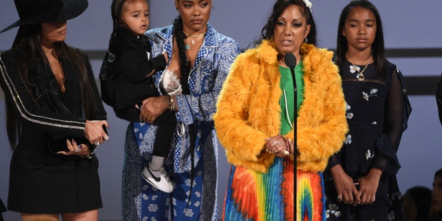 Angelique Smith, mother of late rapper Nipsey Hussle, accepts the humanitarian award on behalf of his son at the BET Awards on Sunday, June 23, 2019, at the Microsoft Theater in Los Angeles. Looking on from background left are Lauren London, Hussle's partner, son Kross, sister Samantha Smith, and daughter Emani Asghedom.