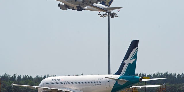 Singapore's Civil Aviation Authority says 63 flights were delayed or diverted as a result of unauthorized drone activity and bad weather.