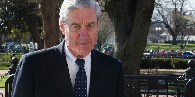 Then-special counsel Robert Mueller walking past the White House in March 2019. (AP Photo/Cliff Owen, File)