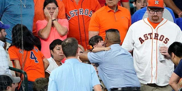 FILE - In this Wednesday, May 29, 2019, file photo, a young child is carried from the stands after being injured by a foul ball off the bat of Chicago Cubs' Albert Almora Jr. during the fourth inning of a baseball game against the Houston Astros, in Houston. (AP Photo/David J. Phillip, File)