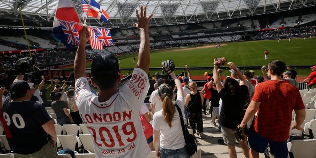 Fans cheer during batting practice before a baseball game between the Boston Red Sox and the New York Yankees. Major League Baseball makes its European debut today at London Stadium.