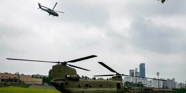 The Marine One helicopter, top, carrying President Donald Trump to the demilitarized zone (DMZ) takes off from Seoul, South Korea, Sunday, June 30, 2019, as a staff helicopter prepares en route to the DMZ. (Associated Press)