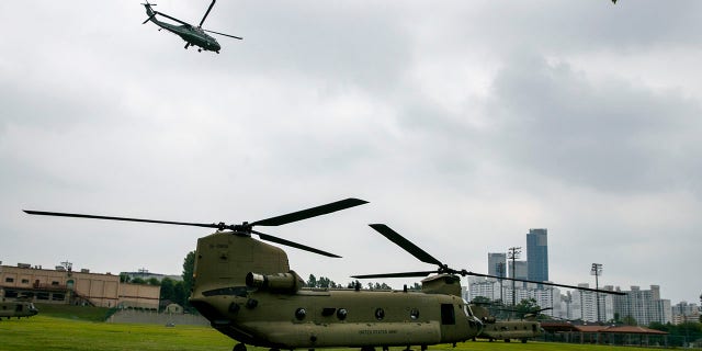 The Marine One helicopter, top, carrying President Donald Trump to the demilitarized zone (DMZ) takes off from Seoul, South Korea, Sunday, June 30, 2019, as a staff helicopter prepares en route to the DMZ. (Associated Press)