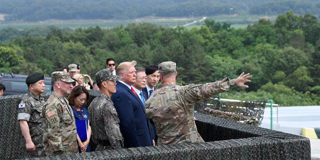 President Donald Trump views North Korea from the Korean Demilitarized Zone from Observation Post Ouellette at Camp Bonifas in South Korea, Sunday, June 30, 2019. (Associated Press)