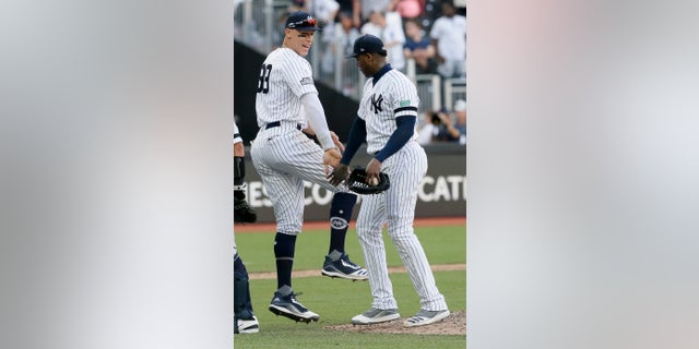 New York Yankees right fielder Aaron Judge, left, and relief pitcher Aroldis Chapman celebrating after their 12-8 win in London on Sunday.