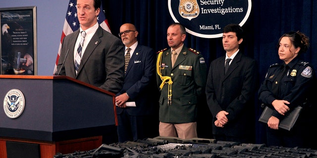 Anthony Salisbury, special agent in charge of ICE's Homeland Security Investigations (HSI) Miami, announces the results of an international weapons trafficking operation with U.S. law enforcement partners in Argentina and Brazil. (Pedro Portal/Miami Herald via AP)