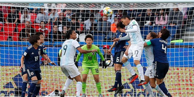 Argentina's Mariela Coronel, center right, and Japan's Hina Sugita fighting for the ball during the match. (AP Photo/Thibault Camus)