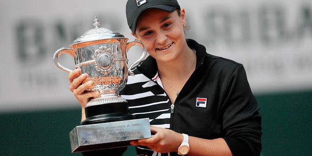 Australia's Ashleigh Barty holds the trophy as she celebrates winning her women's final match of the French Open tennis tournament against Marketa Vondrousova of the Czech Republic in two sets 6-1, 6-3, at the Roland Garros stadium in Paris, Saturday, June 8, 2019.