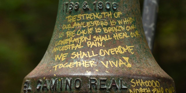 A detailed view of graffiti on an El Camino Real bell marker located at UC Santa Cruz is shown before being officially removed on Friday, June 21, 2019, in Santa Cruz, Calif. (AP Photo/Cody Glenn)