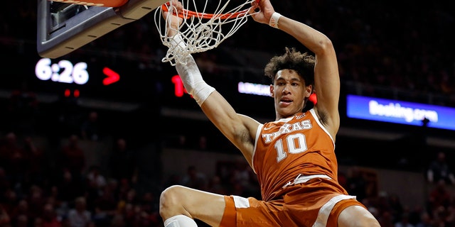 FILE - In this Feb. 2, 2019, file photo, Texas forward Jaxson Hayes (10) dunks the ball over Iowa State guard Nick Weiler-Babb, left, during the first half of an NCAA college basketball game, in Ames, Iowa. Hayes needed only a year at Texas to put himself at the front of the class of big men in the NBA draft coming Thursday, June 20, 2019. (AP Photo/Charlie Neibergall, File)