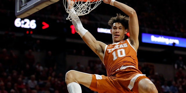 FILE - In this Feb. 2, 2019, file photo, Texas forward Jaxson Hayes (10) dunks the ball over Iowa State guard Nick Weiler-Babb, left, during the first half of an NCAA college basketball game, in Ames, Iowa. Hayes needed only a year at Texas to put himself at the front of the class of big men in the NBA draft coming Thursday, June 20, 2019. (AP Photo/Charlie Neibergall, File)