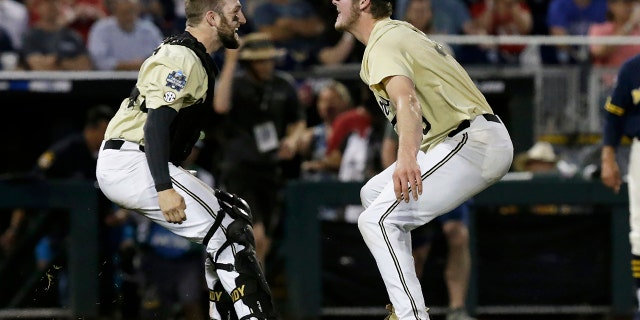 Vanderbilt's Philip Clarke, left, celebrates with Jake Eder after Vanderbilt defeated Michigan in Game 3 of the NCAA College World Series baseball finals in Omaha, Neb., Wednesday, June 26, 2019. (Associated Press)