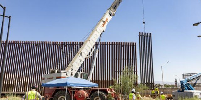 A crane places a section of the new panels in the Calexico area of California