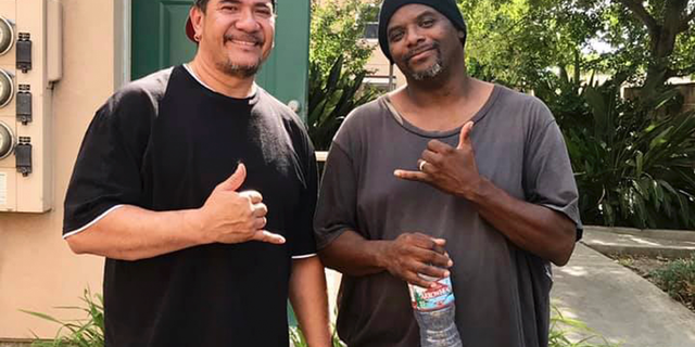 This photo released Tuesday, June 11, 2019, by the Stockton Police Department shows John Pedebone, left, and Troy Cooper, who rescued an abandoned baby in a building's dumpster in Stockton, Calif. The Stockton Police Department says the boy was found wrapped in a plastic bag Tuesday afternoon in Stockton, south of Sacramento. Cooper was unable to get into the dumpster so he called on-site manager Pedebone to rescue the baby. (Stockton Police Department via AP)