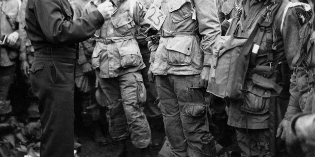 FILE -- June 6, 1944: U.S. Gen. Dwight D. Eisenhower, left, gives the order of the day to paratroopers in England prior to boarding their planes to participate in the first assault of the Normandy invasion. (U.S. Army Signal Corps via AP)