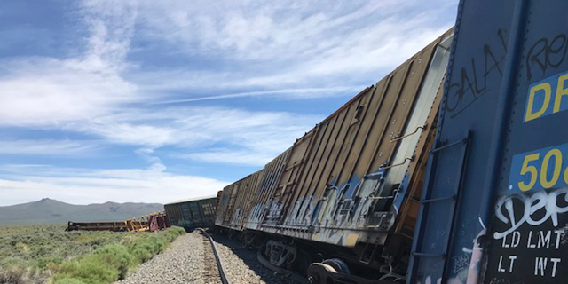 This photo provided by the Nevada Department of Public Safety shows a derailed train Wednesday, June 19, 2019, near Wells, Nev. A train carrying military munitions derailed in the high desert of northeast Nevada, closing an interstate for about an hour before emergency crews determined there was no danger. No injuries were reported. (Nevada Department of Public Safety via AP)