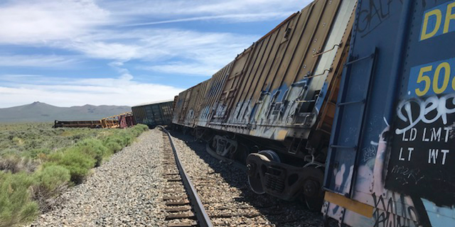 This photo provided by the Nevada Department of Public Safety shows a derailed train Wednesday, June 19, 2019, near Wells, Nev. A train carrying military munitions derailed in the high desert of northeast Nevada, closing an interstate for about an hour before emergency crews determined there was no danger. No injuries were reported. (Nevada Department of Public Safety via AP)