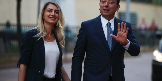 Istanbul's mayoral candidate Ekrem Imamoglu, candidate of the secular opposition Republican People's Party, or CHP, accompanied by his wife, name not given, arrives for a televised debate with Binali Yildirim, of Turkey's ruling Justice and Development Party, or AKP, ahead of the June 23 re-run of Istanbul elections, Sunday, June 16, 2019. Televised election debates are uncommon in Turkey. The last one, between AKP leader Recep Tayyip Erdogan and the then-leader of the CHP, took place before a 2002. The AKP has been in power since. (AP Photo/Emrah Gurel)