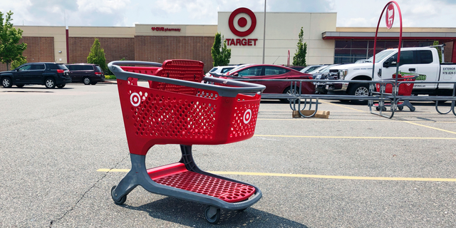 FILE - In this June 3, 2019, file photo a shopping cart sits in the parking lot of a Target store in Marlborough, Mass. On Friday, June 14, the Commerce Department releases U.S. retail sales data for May. (AP Photo/Bill Sikes, File)