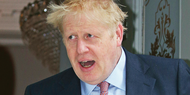 Conservative party leadership contender Boris Johnson leaves his home in London, Monday June 17, 2019. Candidates seeking to beat Boris Johnson and become Britain's next prime minister accused the Brexit-backing front runner of trying to avoid scrutiny after he refused to take part in a televised debate alongside his five rivals Sunday. (Jonathan Brady/PA via AP)
