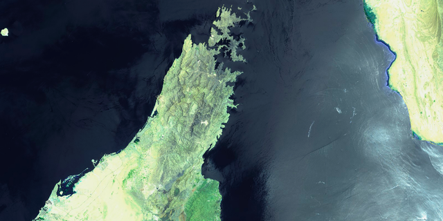 This June 13, 2019 false-color image from the European Commission's Sentinel-2 satellite that was processed by Sinergise's Sentinel Hub website shows the Norwegian-owned MT Front Altair, bottom right, ablaze with smoke rising from it in the Gulf of Oman after what the U.S. described as a limpet mine attack by Iran. Iran has denied being involved in the incident. The land mass to the left is the United Arab Emirates and Oman on the Arabian Peninsula. The land mass in the upper right hand corner is Iran. (European Commission via AP)