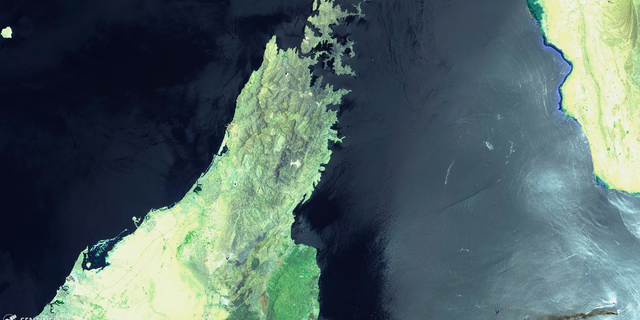 This June 13, 2019 false-color image from the European Commission's Sentinel-2 satellite that was processed by Sinergise's Sentinel Hub website shows the Norwegian-owned MT Front Altair, bottom right, ablaze with smoke rising from it in the Gulf of Oman after what the U.S. described as a limpet mine attack by Iran. Iran has denied being involved in the incident. The land mass to the left is the United Arab Emirates and Oman on the Arabian Peninsula. The land mass in the upper right hand corner is Iran. (European Commission via AP)