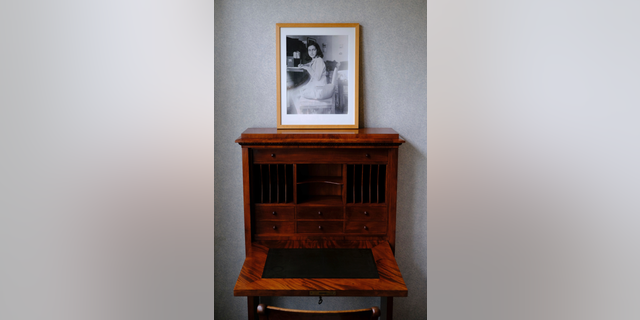 A photo of Anne Frank stands on a replica of the writing desk she once used in her family's former apartment in Amsterdam, during an event to mark what would have been Anne Frank's 90th birthday,  in Amsterdam, Netherlands, Wednesday, June 12, 2019. On the day Anne Frank would have turned 90, the museum dedicated to keeping alive her story has brought together schoolchildren and two of the Jewish diarist's friends at the apartment where she lived with her family before going into hiding from Nazis who occupied the Netherlands during World War II. (AP Photo/Michael C. Corder)