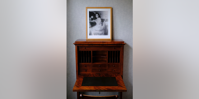 A photo of Anne Frank stands on a replica of the writing desk she once used in her family's former apartment in Amsterdam, during an event to mark what would have been Anne Frank's 90th birthday, in Amsterdam, Netherlands, Wednesday, June 12, 2019. On the day Anne Frank would have turned 90, the museum dedicated to keeping alive her story has brought together schoolchildren and two of the Jewish diarist's friends at the apartment where she lived with her family before going into hiding from Nazis who occupied the Netherlands during World War II. (AP Photo/Michael C. Corder)