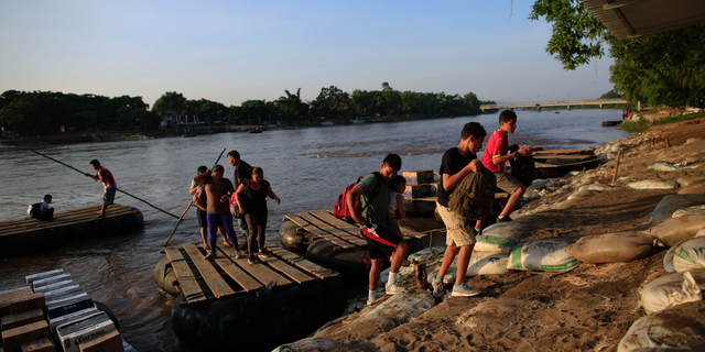 A group of migrants arriving from Guatemala disembark from a raft in Ciudad Hidalgo, Mexico, Tuesday, June 18, 2019. The number of migrants taking rafts at the busy Ciudad Hidalgo crossing point appears to have decreased significantly in recent days amid fears of a pending deployment of the National Guard along the southern border. (AP Photo/Rebecca Blackwell)