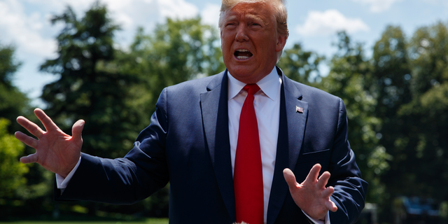 President Donald Trump talks with reporters on the South Lawn of the White House before departing to Japan for the G-20 summit, Wednesday, June 26, 2019, in Washington. (AP Photo/Evan Vucci)