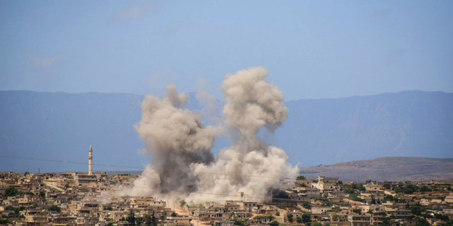 In this May 3, 2019, file photo, smoke rises after Syrian government and Russian airstrikes hit the town of al-Habeet, southern Idlib, Syria. In their latest assault on the last rebel-stronghold of Idlib, the Syrian government and its Russian backer had resorted to familiar tactics to break the will of people and pressure civilians to flee: Target residential areas, bomb hospitals and markets, destroy civilian infrastructure. It is a well-established pattern that worked for President Bashar Assad's forces seeking to recapture Aleppo and other strategic rebel territories during the eight-year war. (Syrian Civil Defense White Helmets via AP, File)