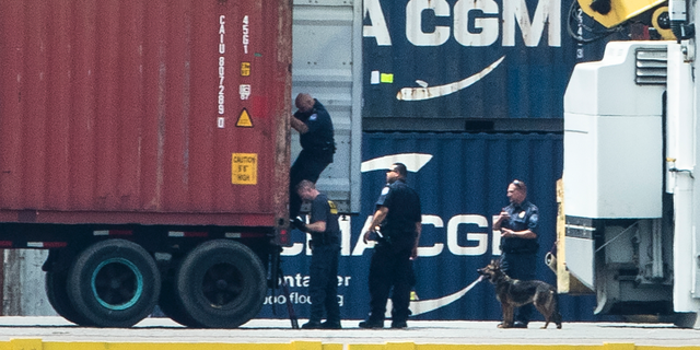Authorities search a container along the Delaware River in Philadelphia, Tuesday, June 18, 2019. U.S. authorities have seized more than $1 billion worth of cocaine from a ship at a Philadelphia port, calling it one of the largest drug busts in American history. The U.S. attorney’s office in Philadelphia announced the massive bust on Twitter on Tuesday afternoon. Officials said agents seized about 16.5 tons (15 metric tons) of cocaine from a large ship at the Packer Marine Terminal. (AP Photo/Matt Rourke)
