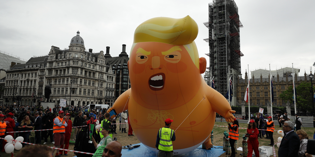The 'Trump Baby' blimp was inflated in Parliament Square in central London as people gathered to demonstrate against the state visit of President Donald Trump, Tuesday, June 4, 2019. Trump joined British Prime Minister Theresa May for a day of talks on Tuesday. (AP Photo/Matt Dunham)