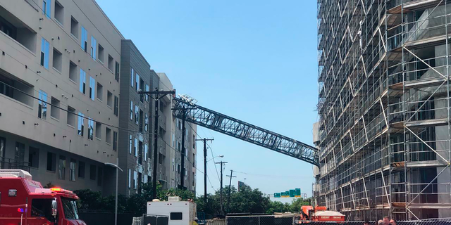 This photo taken and provided by Michael Santana shows a construction crane toppling on an apartment building as it was buffeted by high winds during a storm in Dallas, Texas, Sunday, June 9, 2019. (Michael Santana via AP)