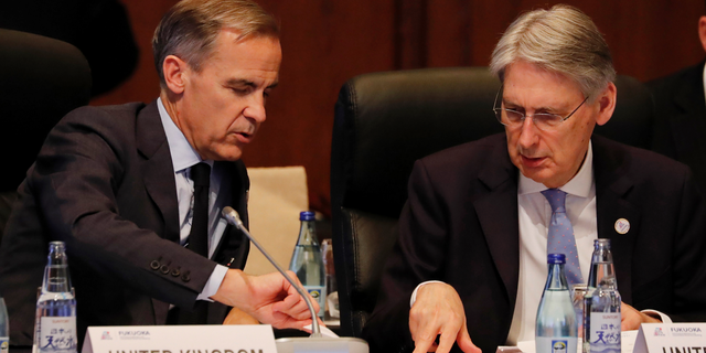 Bank of England Governor, Mark Carney talks with British Chancellor of the Exchequer Philip Hammond during the G20 Finance Ministers and Central Bank Governors Meeting, Saturday, June 8, 2019, in Fukuoka, Japan. (Kim Kyung-hoon/Pool Photo via AP)