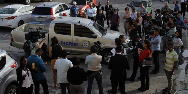 Journalists surround the police vehicle carrying Eddy Vladimir Féliz Garcia who was taken into custody in connection with the shooting of former Boston Red Sox slugger David Ortiz, as he is taken to court in Santo Domingo, Dominican Republic, Tuesday, June 11, 2019. His lawyer, Deivi Solano, said Féliz Garcia had no idea who he’d picked up and what was about to happen, and that he expected Féliz Garcia would be charged as an accomplice to an attempted murder. (AP Photo/Roberto Guzman)