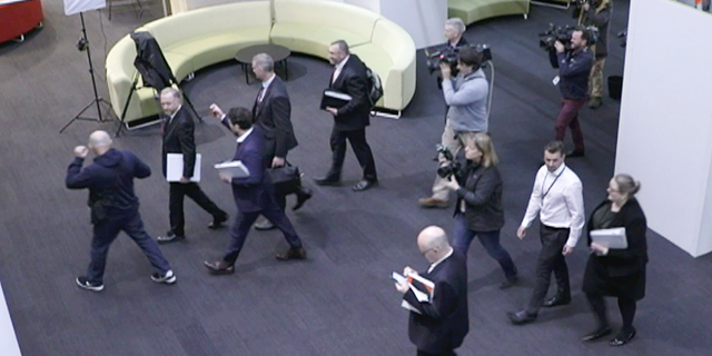In this image made from video, Australia's Federal Police, top, enter the Australian Broadcasting Corporation, the national public broadcaster, during a raid on their offices in Sydney, Australia. The Federal Police raided the offices in connection to a 2017 story based on leaked military documents that indicated the country’s military forces were being investigated for some of their actions in Afghanistan. (Australian Broadcasting Corporation via AP)