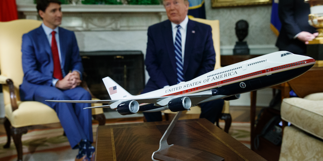 President Trump and Canadian Prime Minister Justin Trudeau meeting in the Oval Office this past June, behind a model of the new Air Force One design. (AP Photo/Evan Vucci, File)