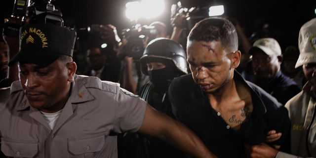 Eddy Vladimir Feliz Garcia, in custody in connection with the shooting of former Boston Red Sox slugger David Ortiz, is transferred by police to court in Santo Domingo, Dominican Republic, Tuesday, June 11, 2019. His lawyer Deivi Solano said Feliz Garcia had no idea who he'd picked up and what was about to happen, and that he expected Feliz Garcia would be charged as an accomplice to an attempted murder. (AP Photo/Roberto Guzman)
