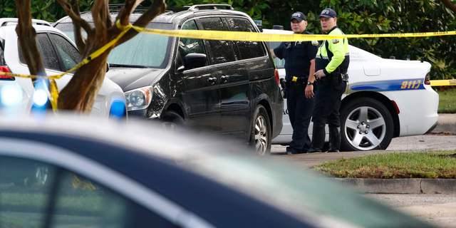 Law enforcement officials work outside a municipal building that was the scene of a shooting, Saturday, June 1, 2019, in Virginia Beach, Va. A longtime city employee opened fire at the building Friday before police shot and killed him, authorities said. (AP Photo/Patrick Semansky)