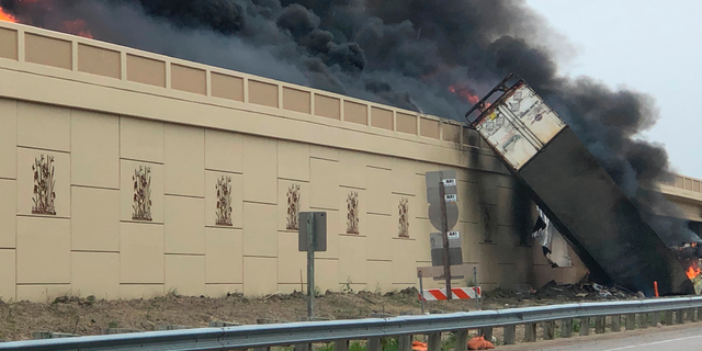 Smoke billows from a semi after a deadly crash on Interstate 94 in Caledonia, Wis, Wednesday, June 19, 2019. Authorities said the semi crashed and exploded and ignited other vehicles on the interstate in southeastern Wisconsin.  (Katelyn Planka via AP)