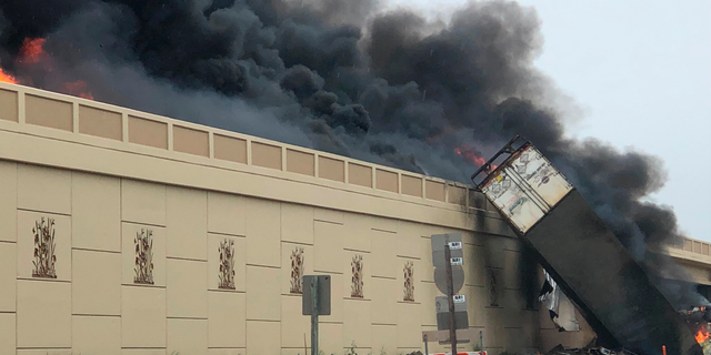 Smoke billows from a semi after a deadly crash on Interstate 94 in Caledonia, Wis, Wednesday, June 19, 2019. Authorities said the semi crashed and exploded and ignited other vehicles on the interstate in southeastern Wisconsin. (Katelyn Planka via AP)