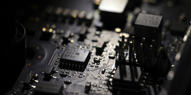 FILE - This Feb 23, 2019, file photo shows the inside of a computer in Jersey City, N.J. Facebook unveiled a broad plan Tuesday, June 18, to create a new digital currency. (AP Photo/Jenny Kane, File)