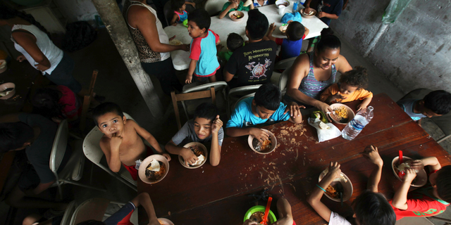 FILE - In this May 30, 2019 file photo, Honduran migrant children eat a meal at the Jesus el Buen Pastor del Pobre y el Migrante shelter in Tapachula, Chiapas state, Mexico. The federal government will be opening a facility at an Army base in Oklahoma to house migrant children and is considering a customs port in southern New Mexico as another option as existing shelters are overwhelmed. The Office of Refugee Resettlement said Tuesday, June 11, 2019 it's dealing with a dramatic spike in the number of children crossing the border without parents. (AP Photo/Marco Ugarte, File)