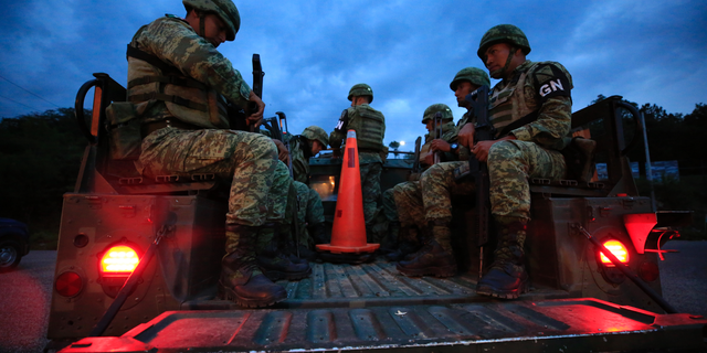 Soldiers forming part of Mexico's National Guard board a truck to patrol back roads used to circumvent a migration checkpoint, in Comitan, Chiapas state, Mexico, Saturday, June 15, 2019. Under pressure from the U.S. to slow the flow of migrants north, Mexico plans to deploy thousands of National Guard troops by Tuesday to its southern border region. (AP Photo/Rebecca Blackwell)