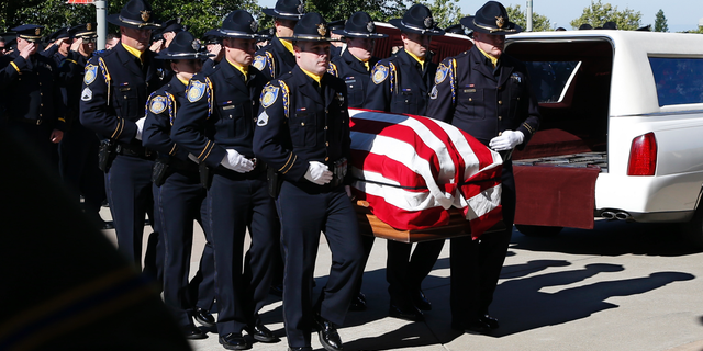 The flag-draped casket of Sacramento Police Officer Tara O'Sullivan is carried into the Bayside Adventure Church for memorial services in Roseville, Calif., Thursday, June 27, 2019. O'Sullivan was shot and killed responding to a domestic violence call.